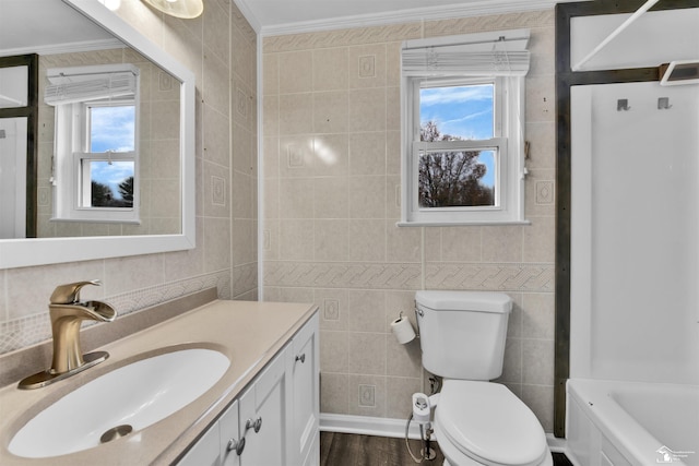 bathroom with wood-type flooring, vanity, tile walls, and ornamental molding