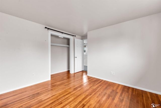 unfurnished bedroom featuring a closet and light hardwood / wood-style flooring