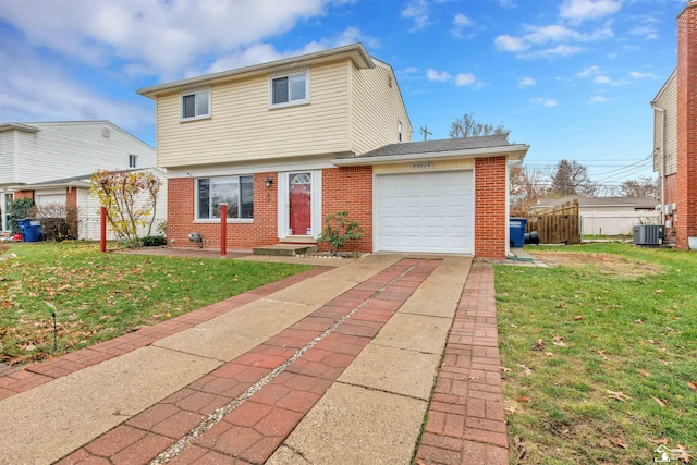 view of property featuring central air condition unit, a front lawn, and a garage