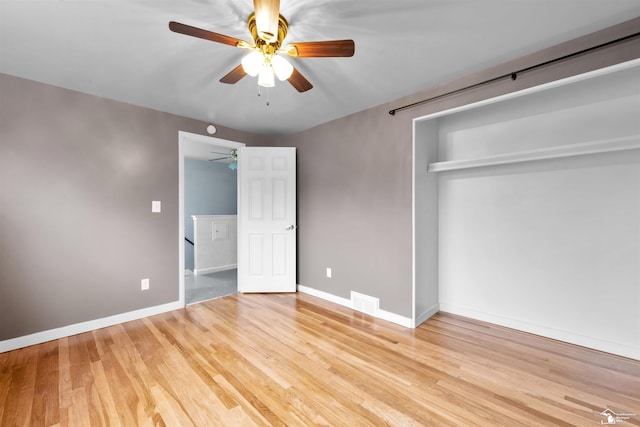 unfurnished bedroom with ceiling fan, a closet, and light hardwood / wood-style flooring