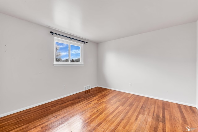 empty room with hardwood / wood-style floors