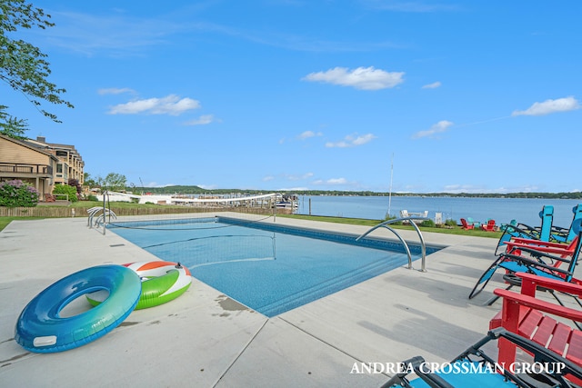 view of swimming pool with a water view and a patio