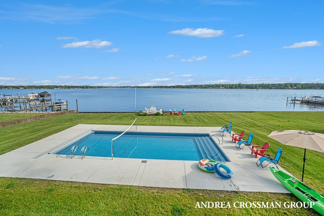 view of swimming pool featuring a lawn and a water view