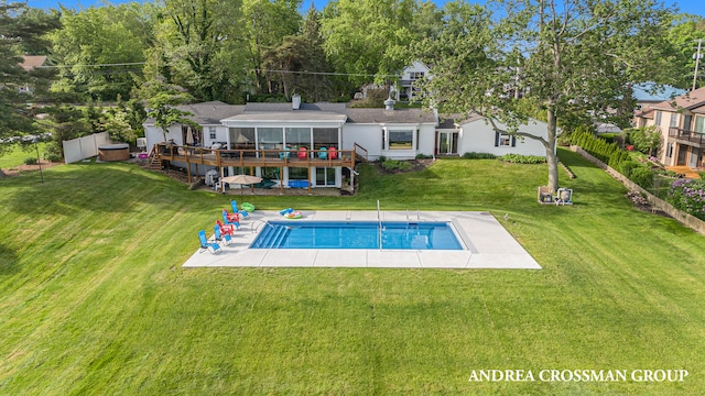 back of house with a pool side deck, a patio area, and a yard