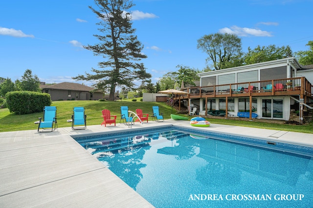 view of pool with a yard and a wooden deck