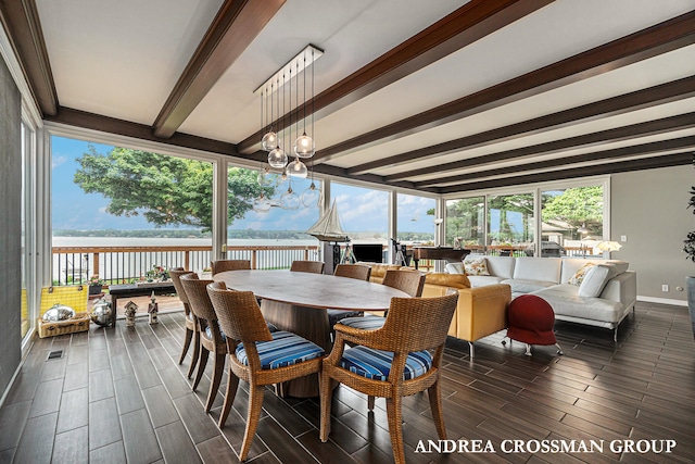 sunroom featuring beam ceiling, a water view, a wealth of natural light, and a notable chandelier