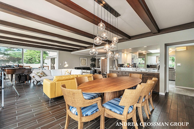 dining space featuring beam ceiling