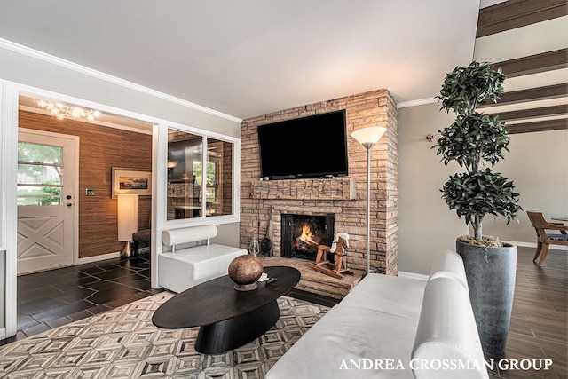 living room with dark wood-type flooring, a fireplace, a healthy amount of sunlight, and ornamental molding