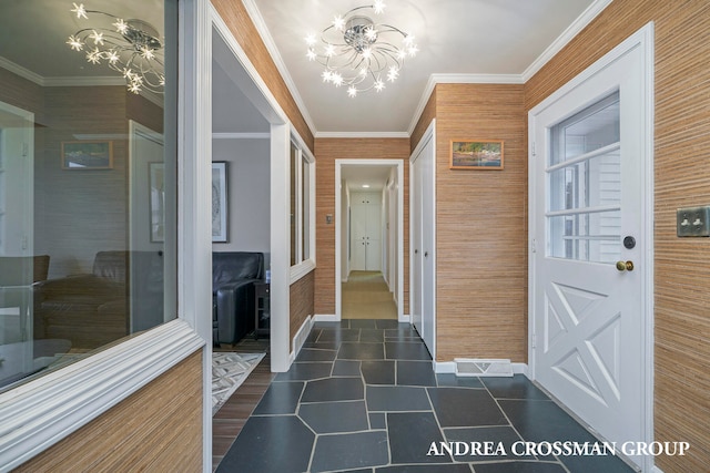 interior space with ornamental molding and a chandelier