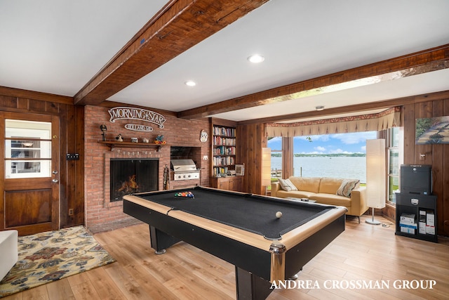 playroom featuring a fireplace, beamed ceiling, light hardwood / wood-style floors, and pool table