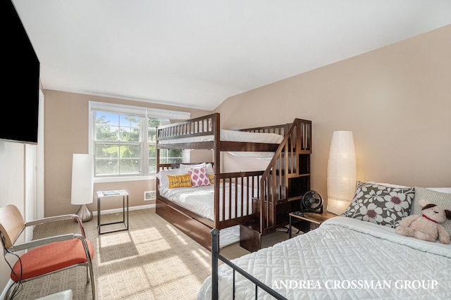 bedroom featuring carpet floors and lofted ceiling