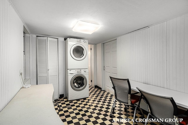 clothes washing area featuring stacked washer / drying machine