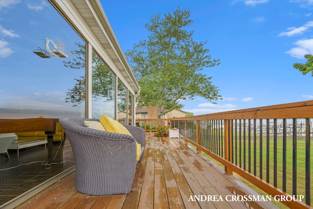 wooden deck with a lawn