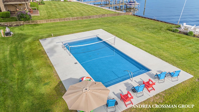 view of pool with a yard and a water view