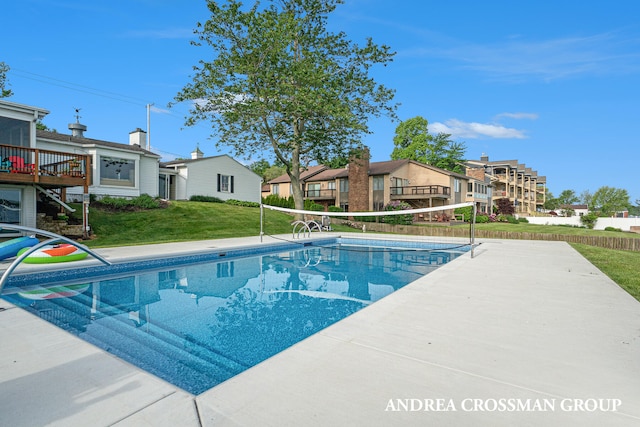 view of pool with a lawn