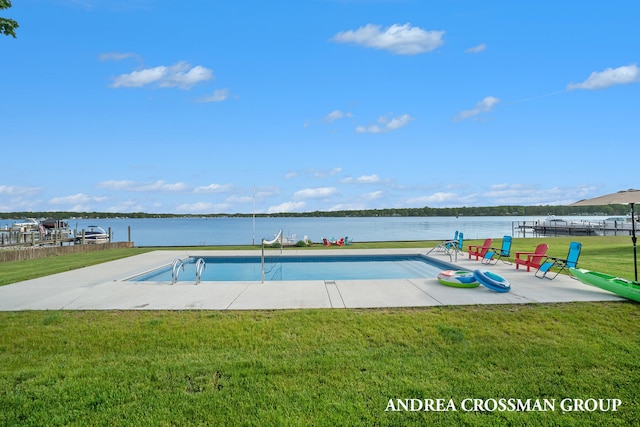 view of pool featuring a yard, a water view, and a patio area