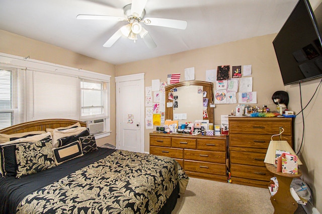 carpeted bedroom featuring ceiling fan and cooling unit