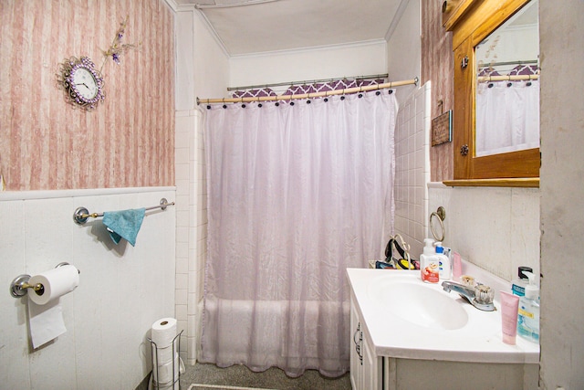 bathroom with crown molding, shower / bath combo with shower curtain, and vanity