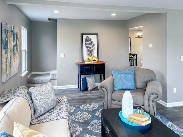 living room with a chandelier and dark hardwood / wood-style flooring