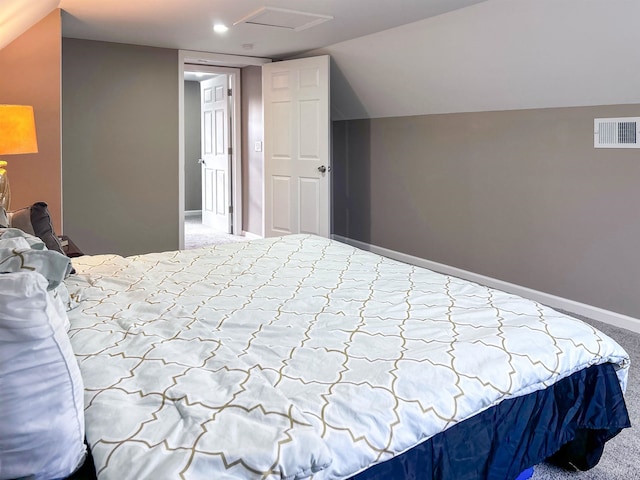 carpeted bedroom with lofted ceiling