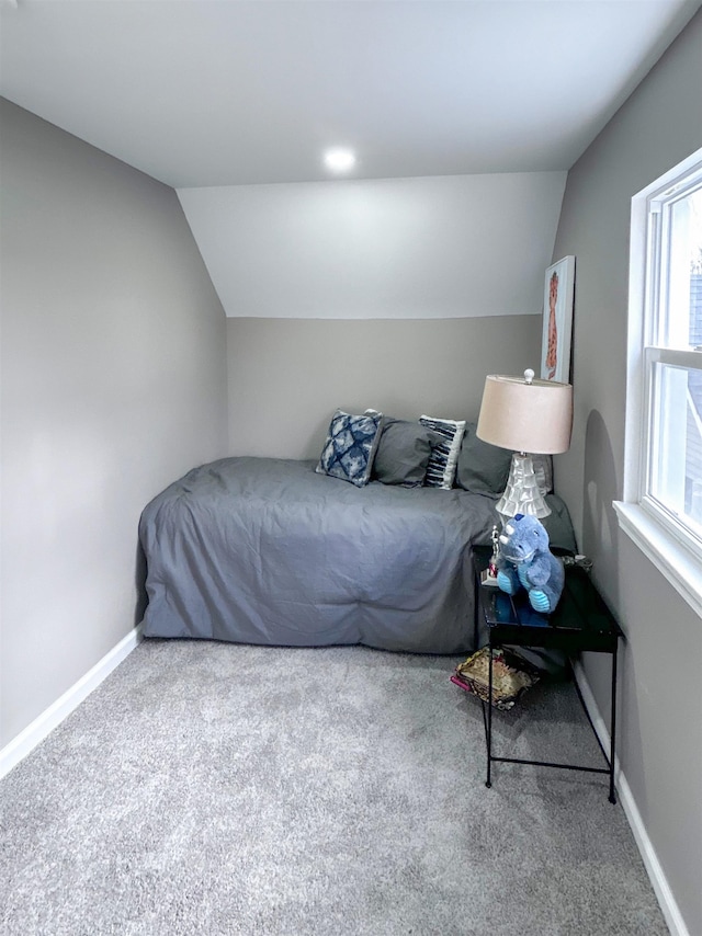 bedroom featuring carpet and lofted ceiling