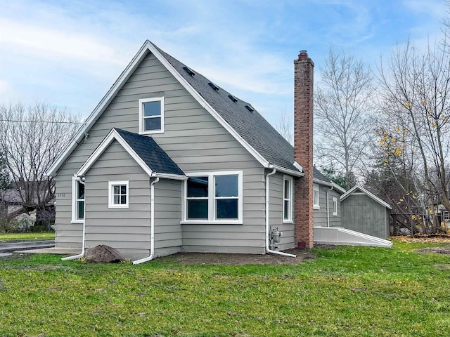 rear view of house featuring a yard