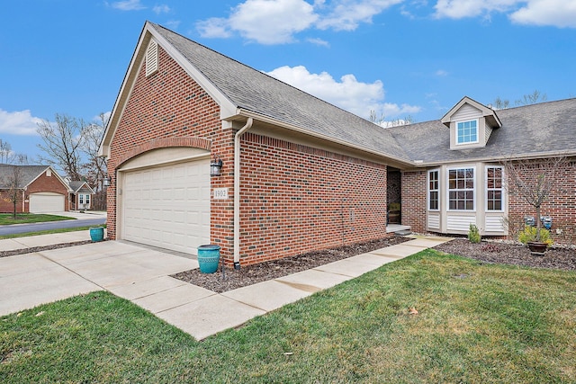 view of side of property with a lawn and a garage