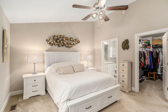 carpeted bedroom featuring a walk in closet, ceiling fan, high vaulted ceiling, connected bathroom, and a closet