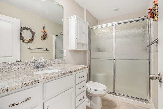 bathroom featuring vanity, toilet, and walk in shower