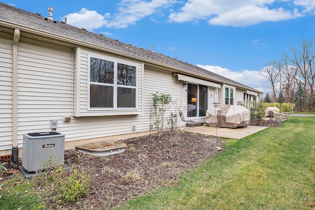 back of property featuring central air condition unit, a yard, and a patio