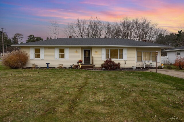 single story home featuring a yard