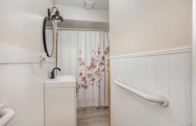 bathroom with hardwood / wood-style floors and sink