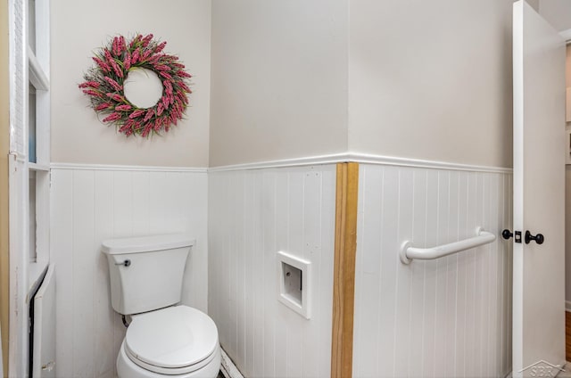 bathroom with toilet and wooden walls