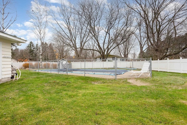 view of yard with a covered pool