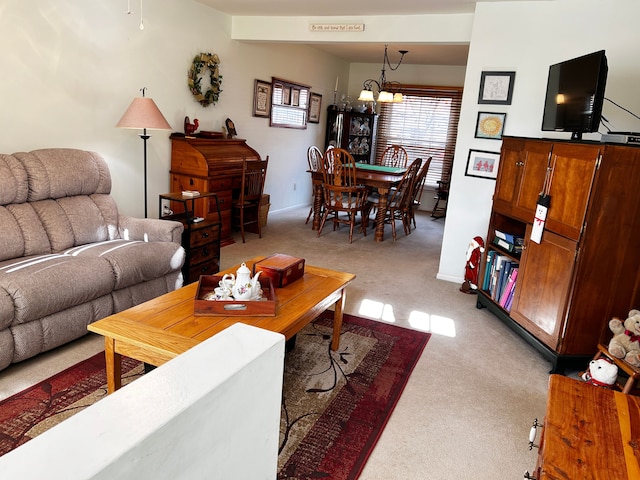 carpeted living room featuring an inviting chandelier