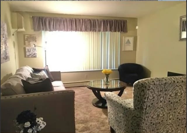 living room featuring light colored carpet and a baseboard radiator