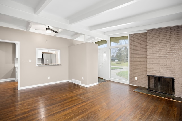 unfurnished living room with dark hardwood / wood-style floors, ceiling fan, lofted ceiling with beams, and a brick fireplace