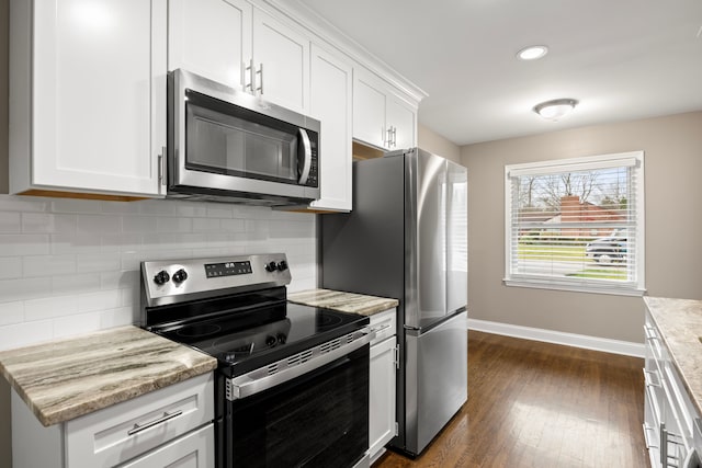 kitchen featuring appliances with stainless steel finishes, dark hardwood / wood-style floors, and white cabinetry