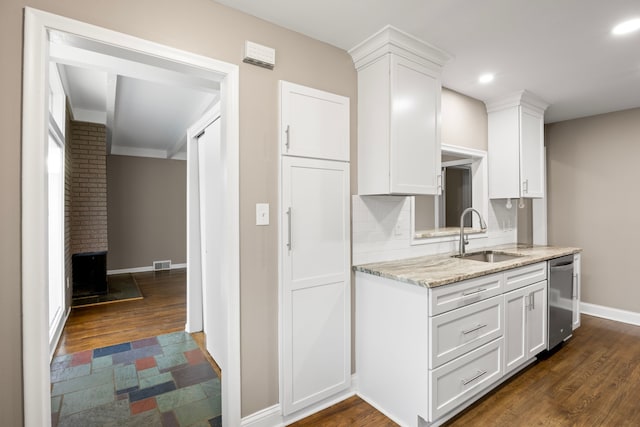 kitchen featuring white cabinets, dark wood-type flooring, dishwasher, and sink