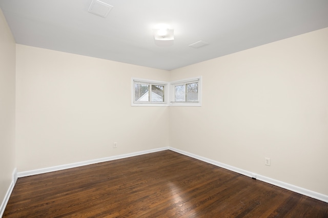 empty room with dark hardwood / wood-style floors