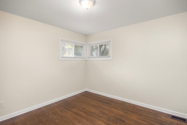 spare room featuring dark hardwood / wood-style flooring