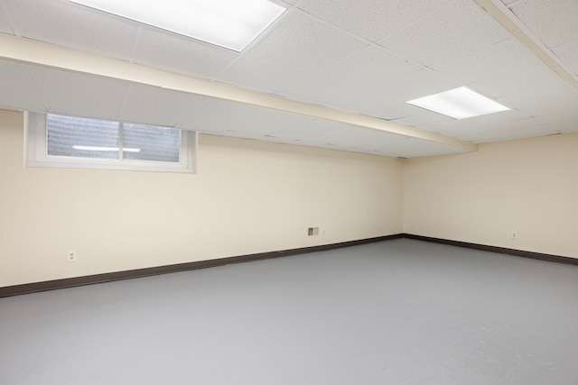 basement featuring a paneled ceiling