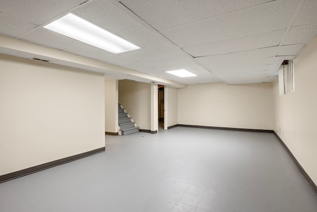 basement with a paneled ceiling