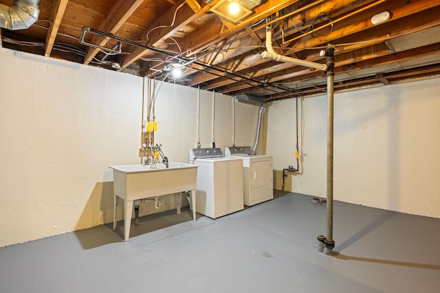 basement with independent washer and dryer and sink