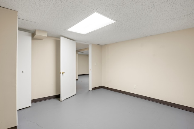 basement with a paneled ceiling