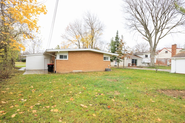 back of property featuring a lawn