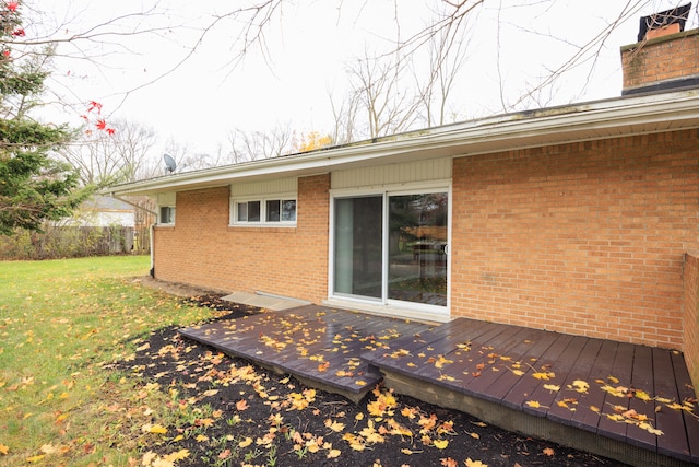 rear view of property with a lawn and a deck