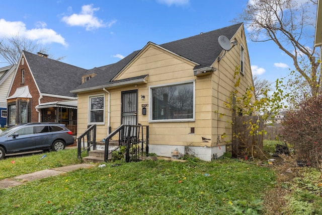 bungalow-style home with a front yard