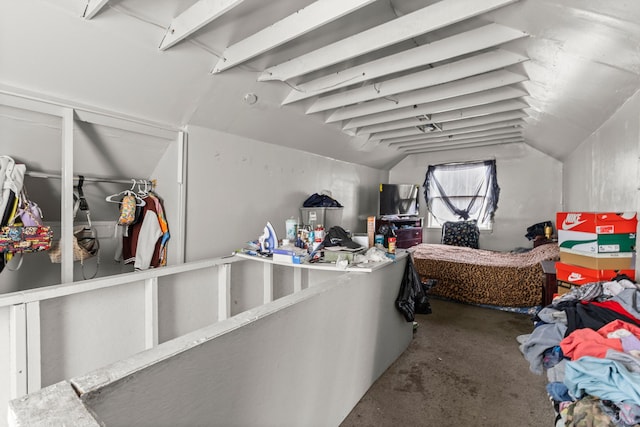 interior space with concrete flooring and vaulted ceiling