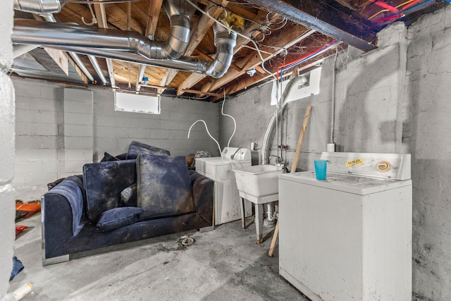 basement featuring washing machine and dryer and sink